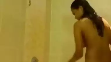Indian girl takes her clothes off and gets into the shower stall for some porn