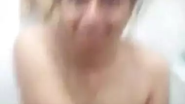 Desi female sits on a toilet bowl with naked XXX boobies and pussy